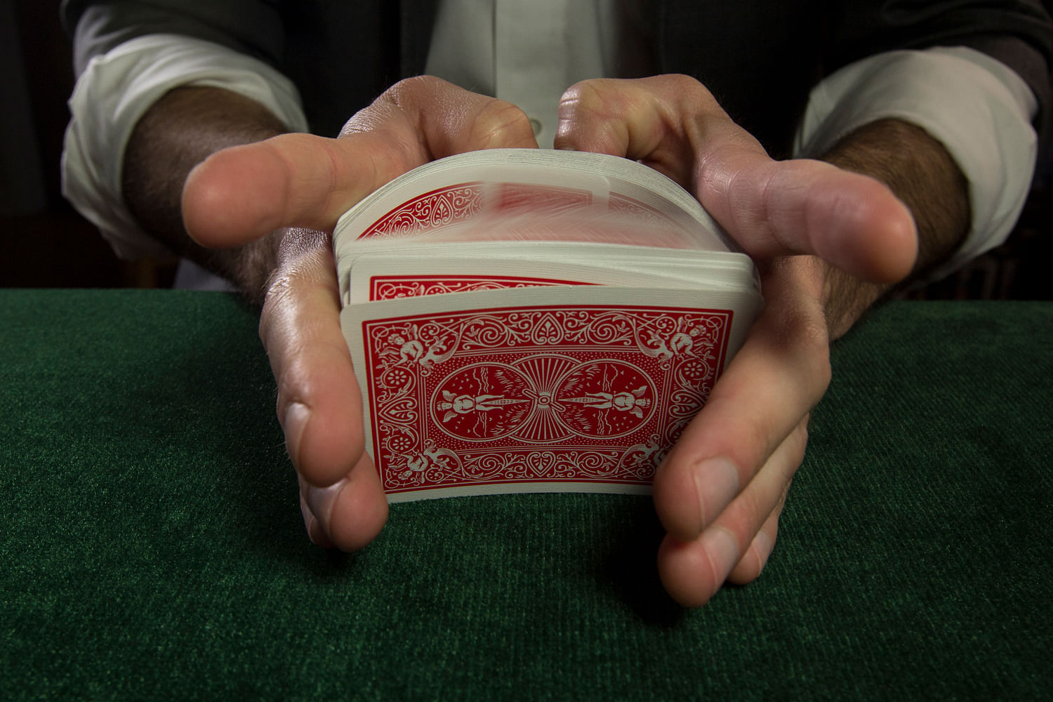 Card mechanic executes a False riffle shuffle to cheat at cards