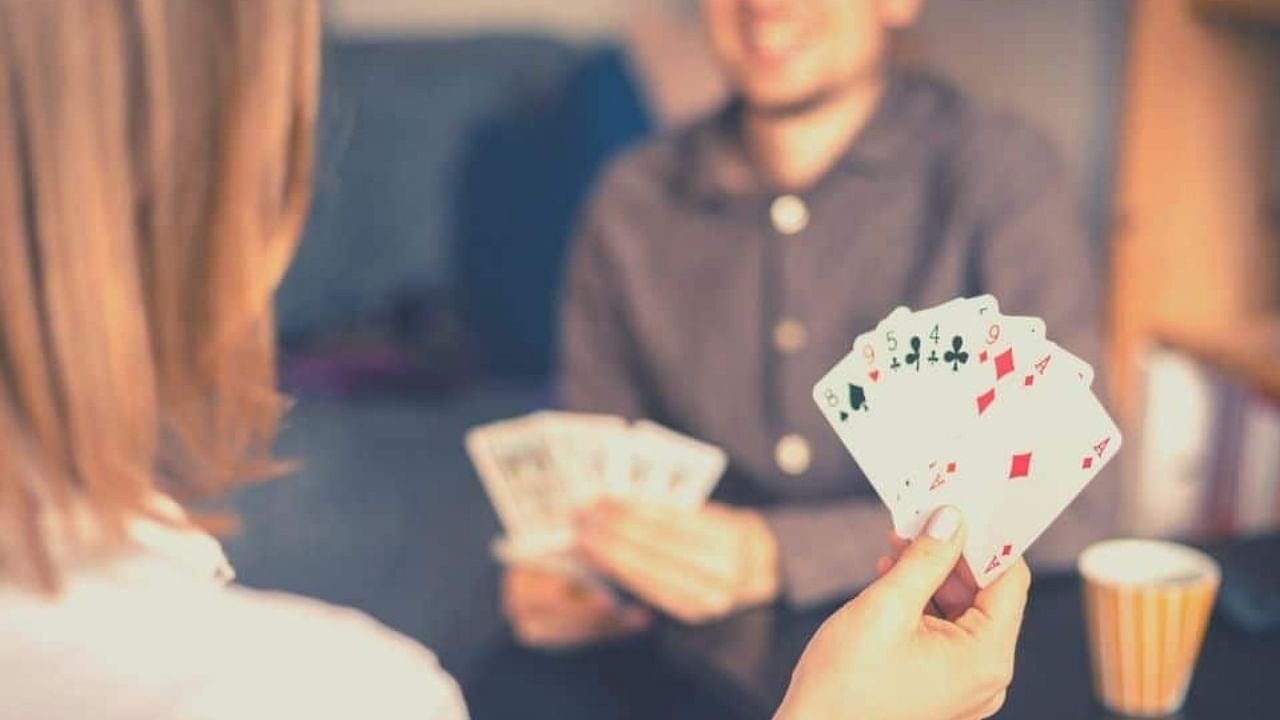 A couple plays a fun card game on game night