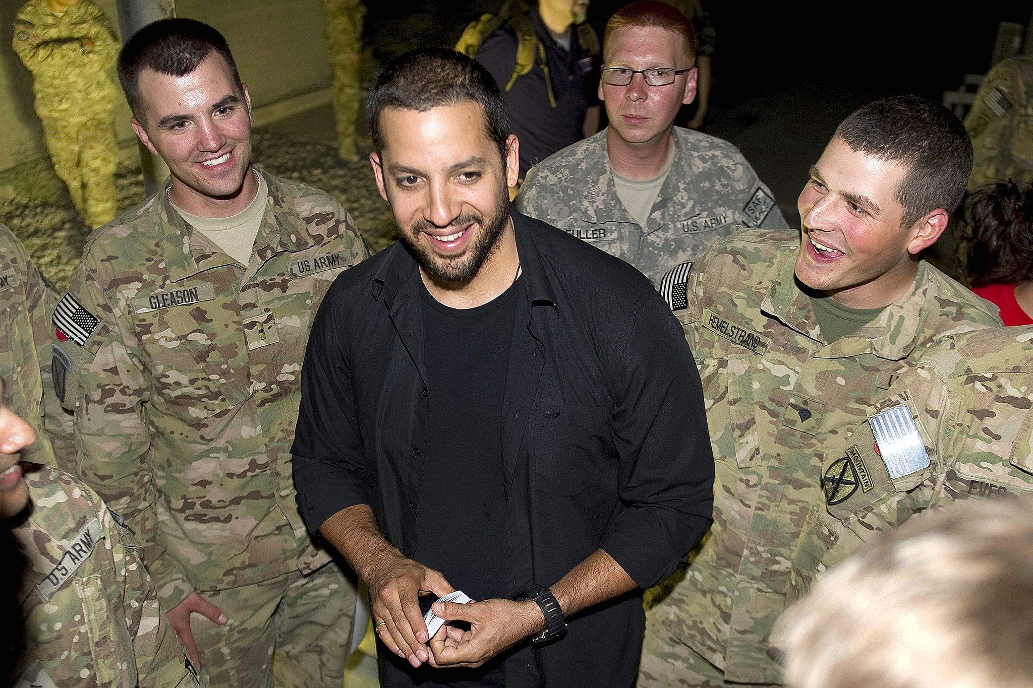 David Blaine performs street magic for members of the United States Army