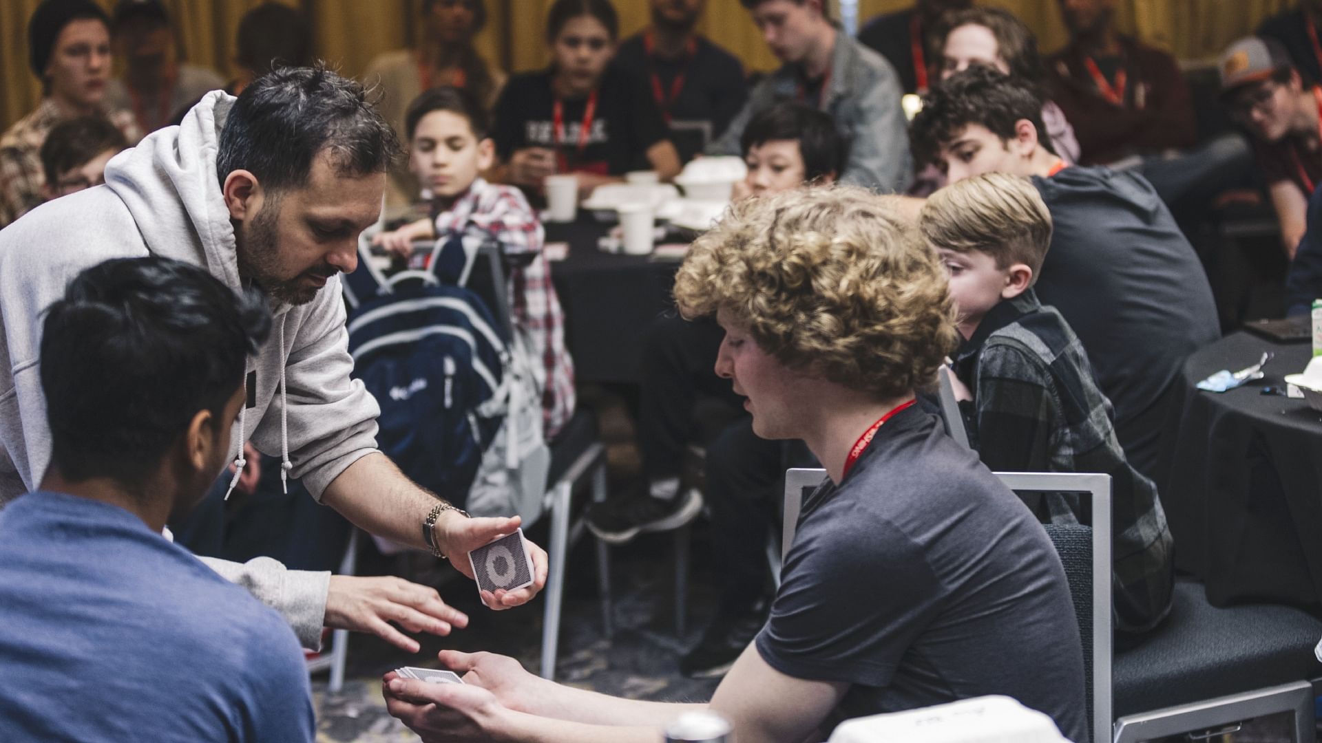 magician Dynamo performs a card trick for kids
