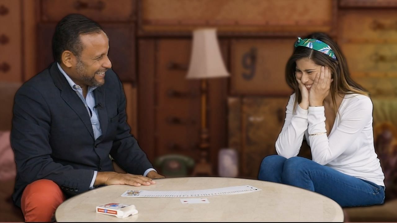 magician performs magic for a girl with a huge smile