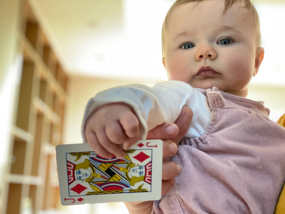 Very cute baby with a playing card