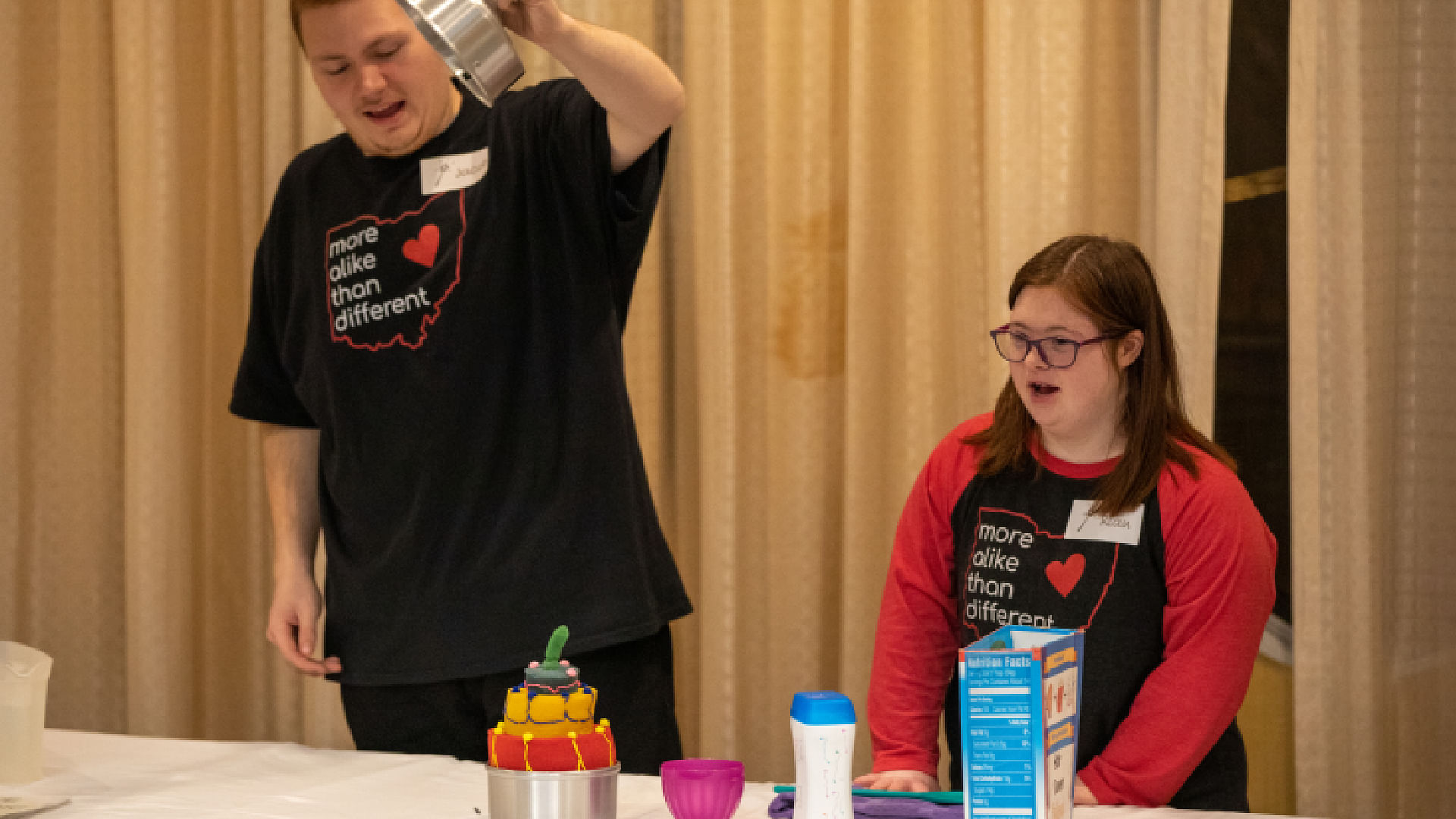 Two young kids are excited to show off an easy magic trick they learned at a magic convention
