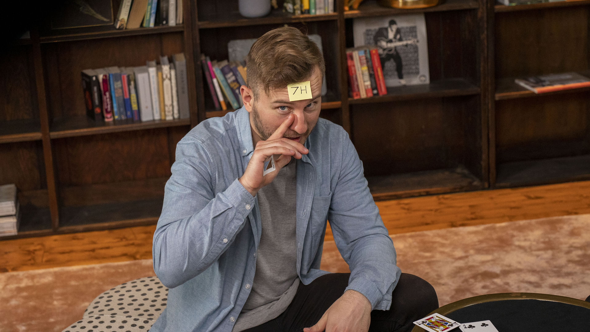 Magician reveals seven of hearts during card trick