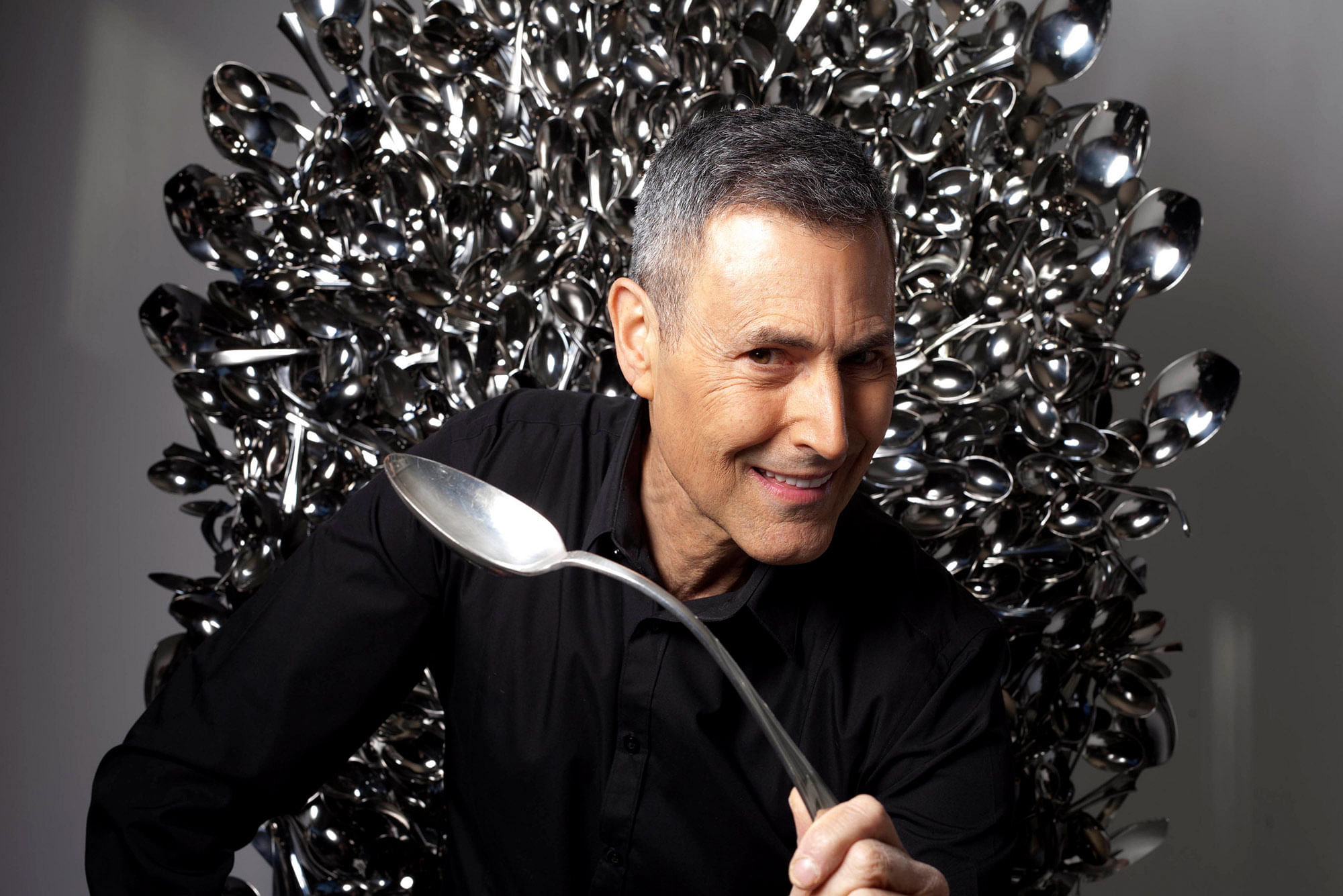 Controversial mentalist, psychic and spoon-bender Uri Geller sits on a throne of lies made of bent spoons